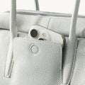 Light blue full-grain leather Yore Toast Bag with phone in front pocket and silver hardware.
