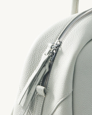 Light blue Yore Toast bag made of full-grain leather with silver hardware zipper detail.