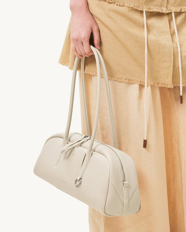Yore Toast Bag in Cloud color, made of full-grain tumbled leather with rounded edges and flowing lines.
