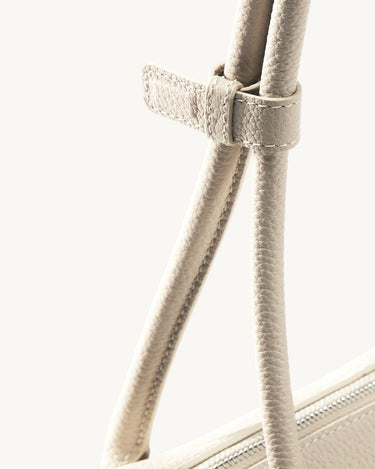 Yore Toast Bag in Cloud: pebbled full-grain leather, rounded handles, and zipper detail.