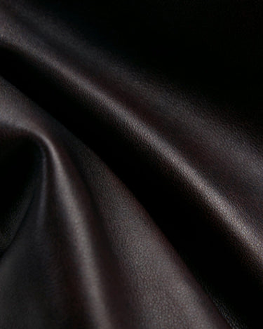 Ebony Nappa leather texture close-up for Yore Toast Bag. Soft, full-grain, rich color.