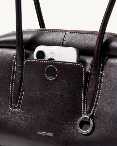 Ebony Yore Toast Bag: Full-grain Nappa leather, contrast stitching, exterior pocket with phone, Songmont logo.