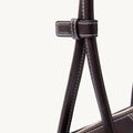 Dark brown Yore Toast Bag by Songmont, featuring leather handle with contrast stitching and silver zipper detail.