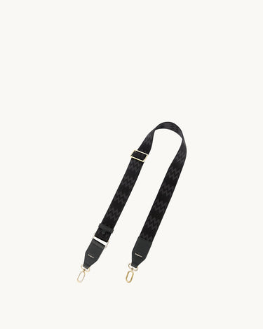 Yore Tote Bag Shoulder Strap in onyx, featuring a black fabric strap with a black and grey zigzag pattern and gold hardware.